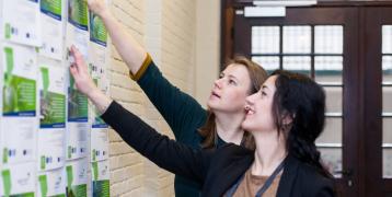 Two women looking at pamphlets