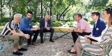 six people talking in a garden 