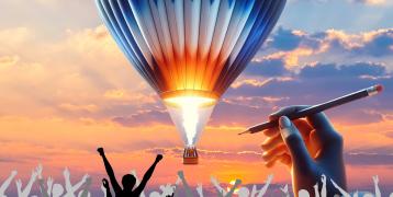 This image portrays a surreal scene with a vibrant sunset and a brightly glowing hot air balloon in the sky. Below, a crowd of silhouetted people appears to be celebrating. Above them, a giant hand holding a pencil suggests it is drawing the balloon, adding a creative and fantastical element to the scene.