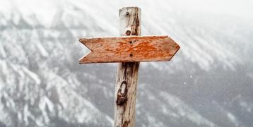 Brown wooden arrow sign