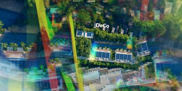 Overhead photograph of solar panels over a green city