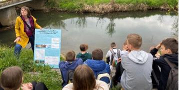 Kids studying outside in front of a river