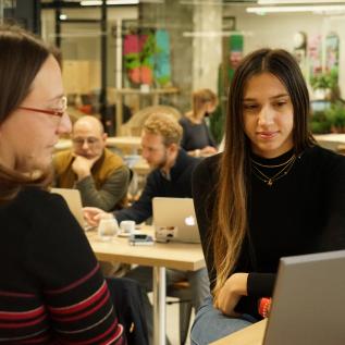 Two people looking at laptop