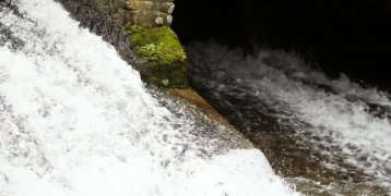 A current of water merging into another body of water